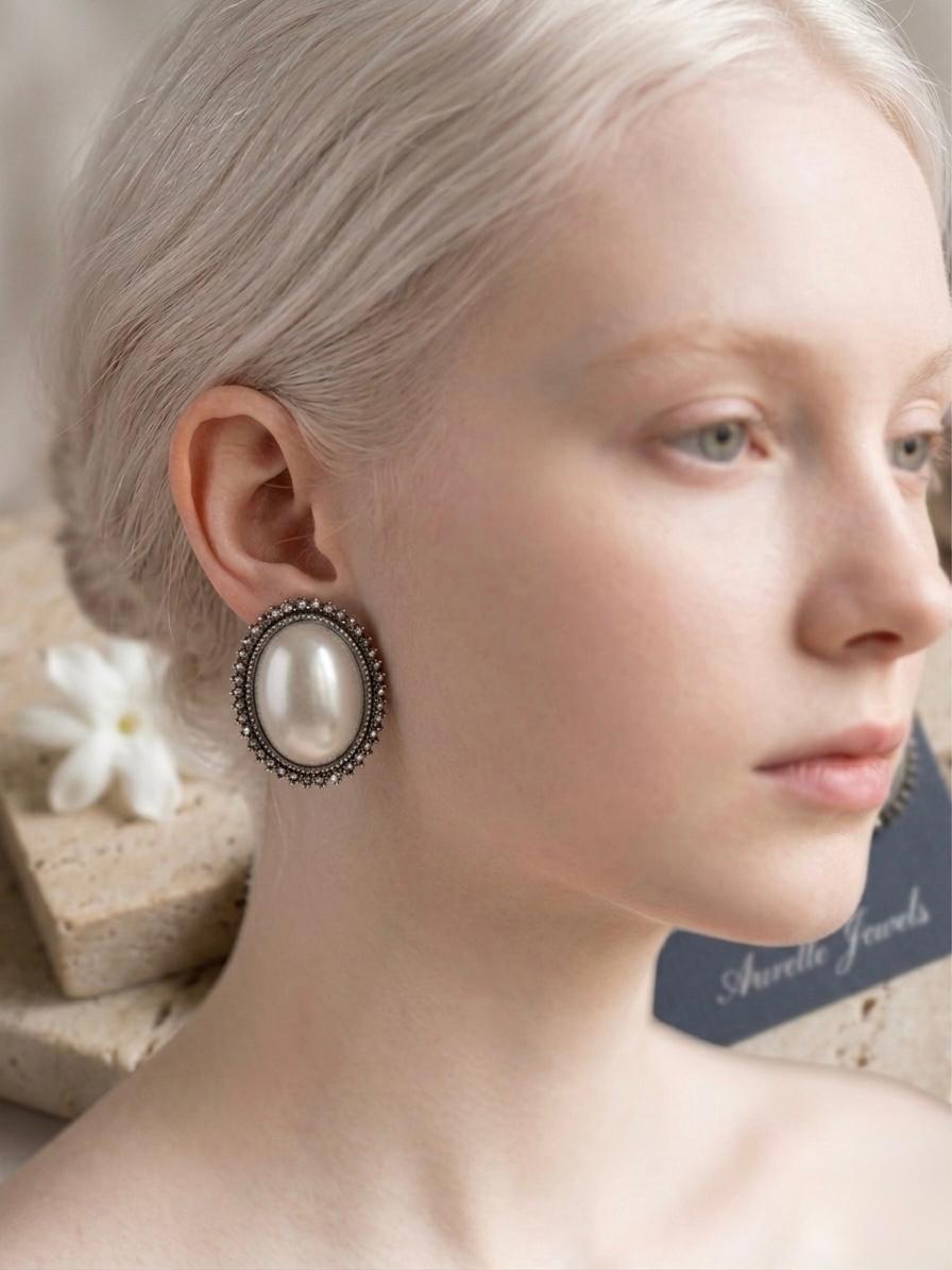Oval Shaped Pearl Studs With Black Metal Border